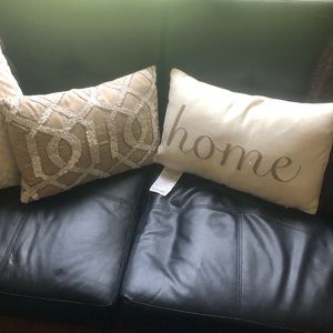 Tan pillow that reads “home”